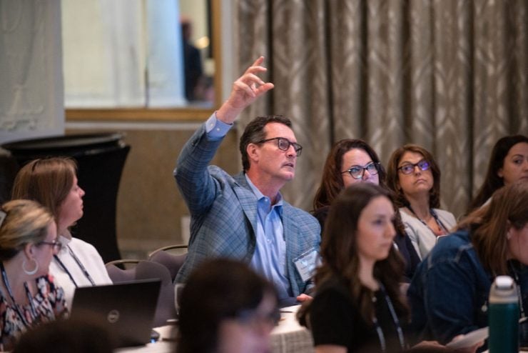 A program participant asking a question at a program