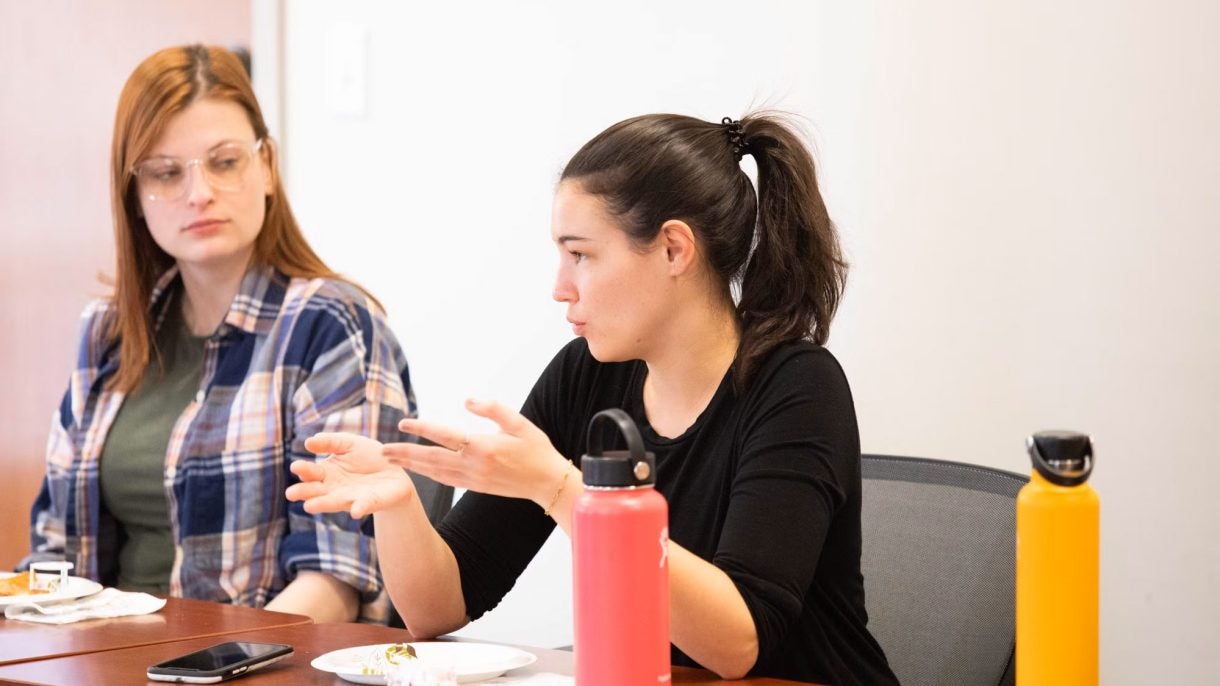 Students at a lunch-and-learn event ask for advice about their career paths.