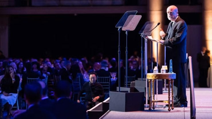 Dean Emeritus William M. Treanor at podium receiving award