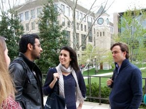 Four Georgetown Law students talking outside in front of the clock tower on the Capitol Campus.