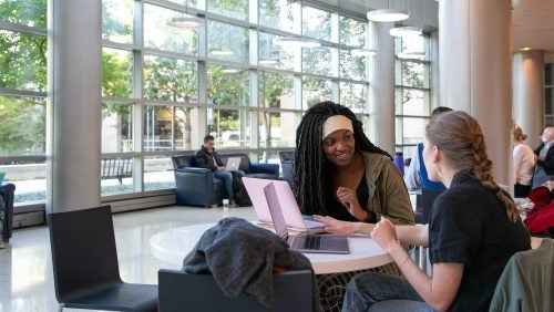 students studying in the lobby of the fitness center