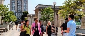 Tour guide speaking to prospective students walking.