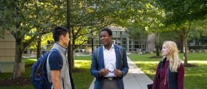 Three students talking on the Tower Green