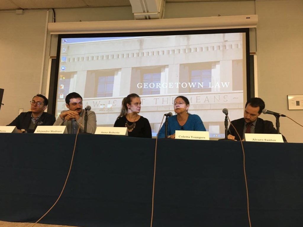 Symposium participants gathered at the panel table