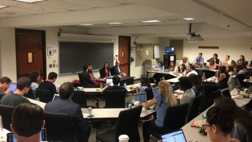 Discussants and students in a classroom