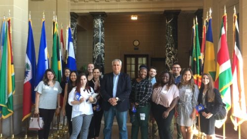 Georgetown Law students standing next to the patio of the OAS building