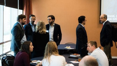 Workshop participants standing during a break