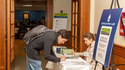 A person is registering at the LAPEG Conference.