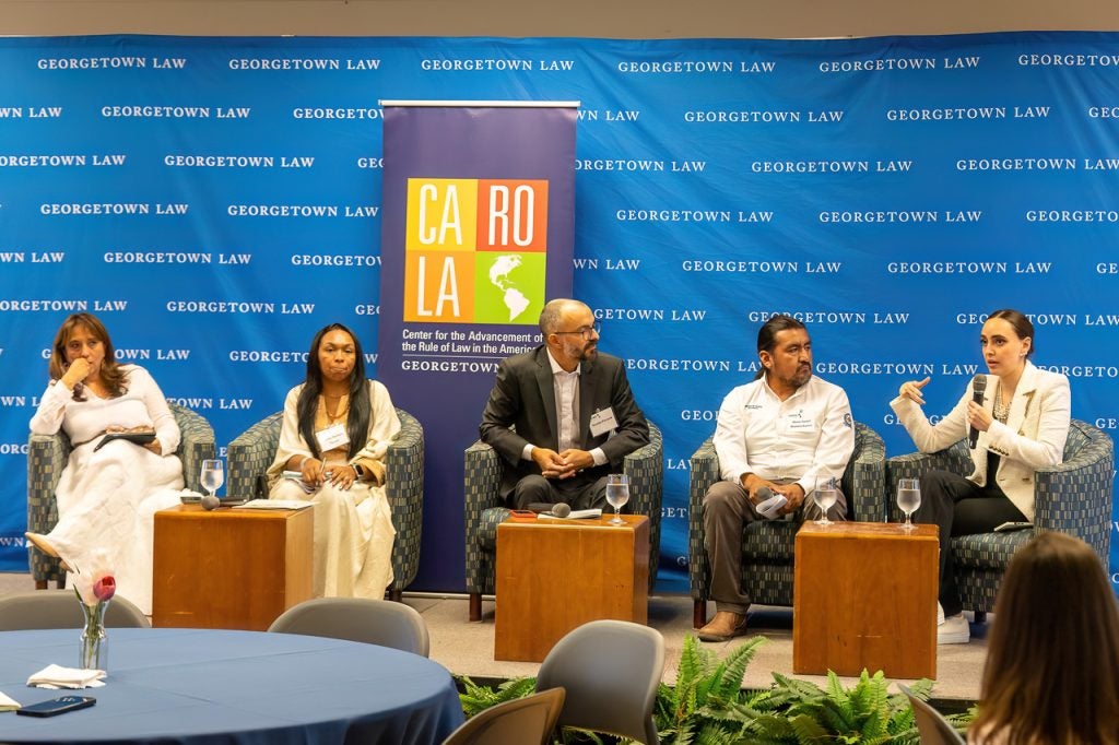 Moderator Nicolas Perrone listening to Altagracia Gomez at the conference while Alexis Romero, Jazmin Romero and Soraya Caro wait their turn.