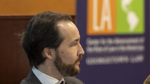 Professor Alvaro Santos looking at a speaker