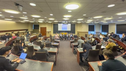 Overview of the room where the panel takes place with guests listening to the panel