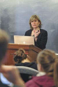 Professor Helen Norton of the Colorado Law School stands at the podium while teaching her law course.
