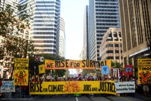 Protestors march in downtown San Francisco ahead of the Global Climate Action Summit.