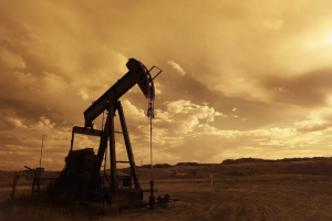 An oil pump, presumably extracting oil in a parcel of barren land.