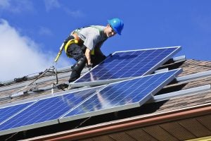 Installation of a rooftop solar photovoltaic system. Image by Greens MPs via Flickr.