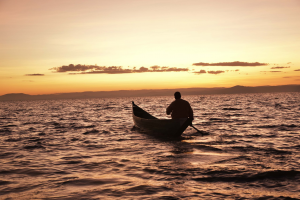 Fisherman paddling on Lake Victoria.