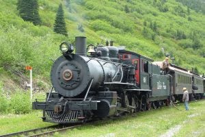 Image of Baldwin Steam Locomotive 69 on the White Pass and Yukon Route; Photo Credit: Nils Öberg, CC BY-SA 3.0 via Wikimedia Commons (https://commons.wikimedia.org/wiki/File:WPYR_Steam_train_at_Glacier.JPG)