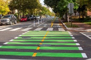 Bike lanes, low speed limits, sidewalks protected from drivers by parked cars and trees, and crosswalks improve safety and comfort for walking and biking in this D.C. neighborhood.  