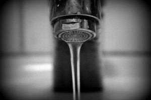 Water flows from a kitchen faucet.  