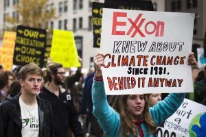 Protestors holding signs. Photo: Johnny Silvercloud: https://www.flickr.com/photos/johnnysilvercloud/22286952533/in/album-72157661035041231/.