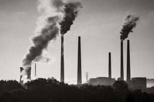 Smokestacks disperse pollutants into the atmosphere.
