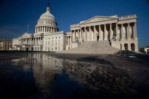 The United States Capitol building and its reflection in a pool of water.  
