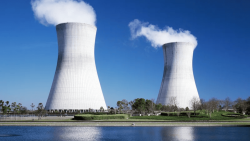 A water source with two large nuclear cooling towers in the background.