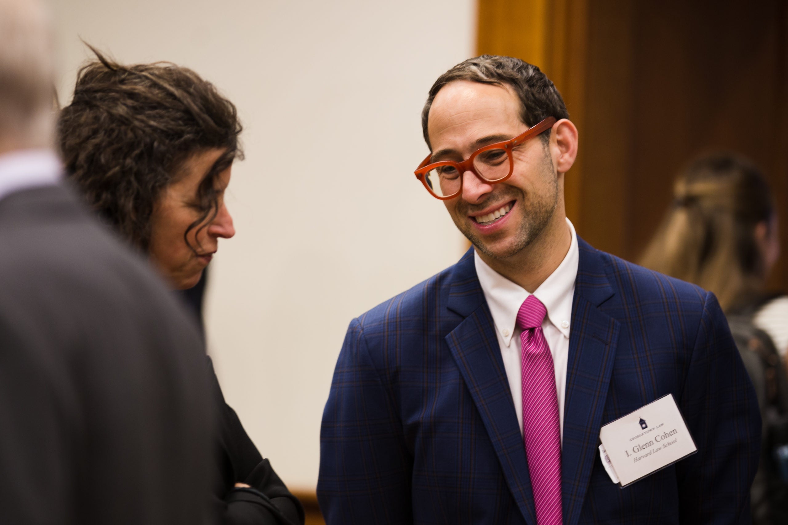 Photo gallery of various speakers and attendees.