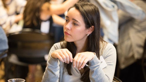 Fact-Finding Practicum student Ingrid Schulz watches her colleagues present the team's findings at the 2019 Dash Conference