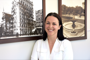 Woman standing in front of vintage photographs