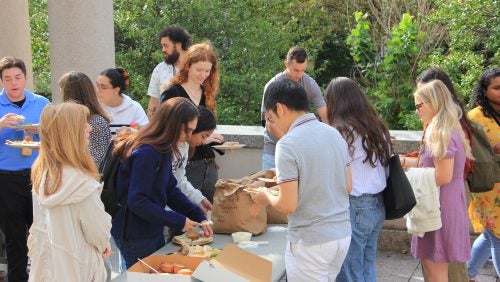 Associates mingle with other students at brunch outside