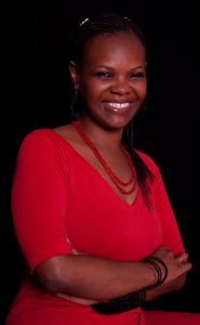 Woman in red top against black background.