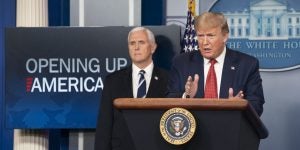 President Trump speaking at a podium with Vice President Pence behind him. They are at a press conference to announce the "Opening of America" Plan