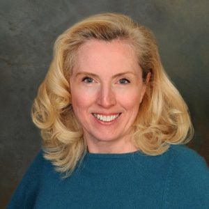 Headshot of Amy O'Hara, a smiling woman with blonde hair and a blue sweater.