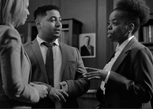 Black and white photo of several professionals talking together