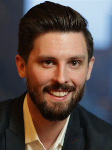 Jason Tashea: A smiling man with a beard