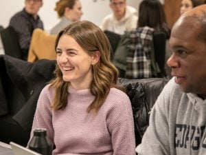A student smiles in a crowded classroom