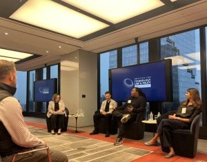 4 individuals speak in a panel at Cooley LLP's office, in front of a Tech Institute sign.