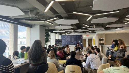 Professor Calo speaks to a room full of attendees.