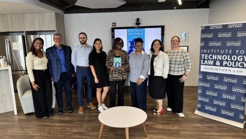 Nicol Turner Lee and Nina-Simone Edwards stand for a picture with other attendees.