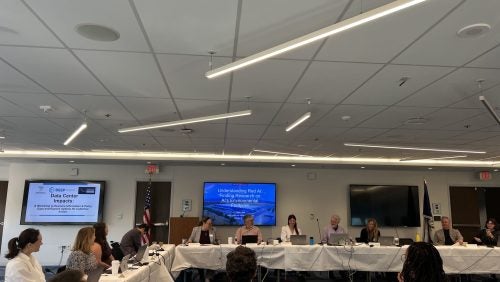 Participants convene for a conversation about data centers around tables.