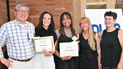 Nina-Simone Edwards and Brenda Dvoskin smile with their awards, alongside 3 other individuals.