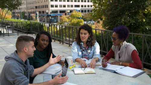 Students seated outside McDonough Hall