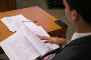 student turning pages of a law textbook