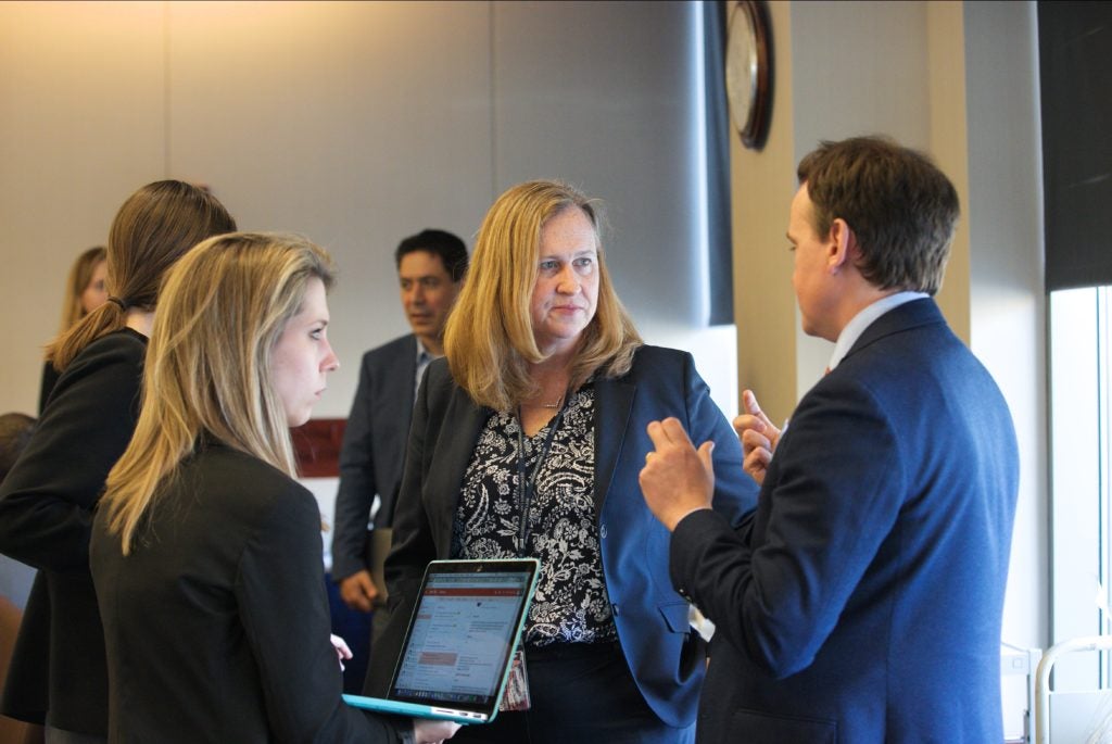 Laura Donohue meets with students during the Simulation.