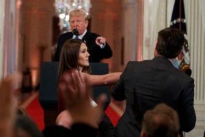President Donald Trump looks on as a White House aide takes away a microphone from CNN journalist Jim Acosta during a news conference in the East Room of the White House, Wednesday, Nov. 7, 2018, in Washington. (AP Photo/Evan Vucci)