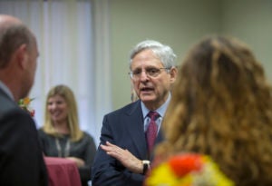 Chief Judge Merrick B. Garland, center, speaks to Georgetown Law Dean William M. Treanor and Natalie Tverdynin (L'21).