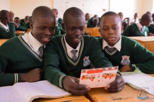 Students at St. Aloysius in Nairobi read letters and cards from Georgetown students.