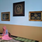 Student reading book in Muslim Prayer Room