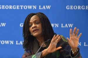 Rhoda Weeks-Brown, general counsel of the IMF, speaks on a panel in front of a microphone.